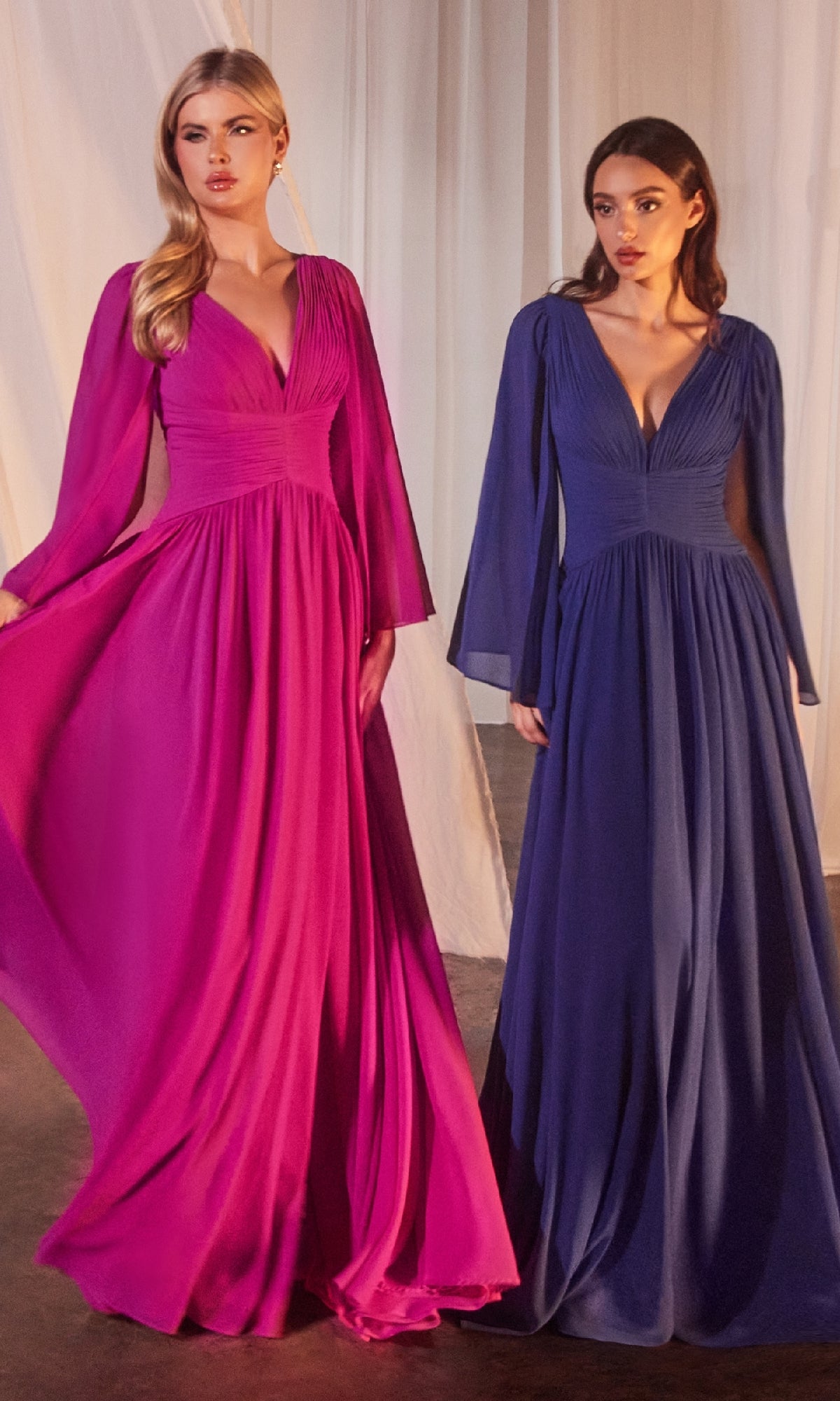 Two women stand side by side in a softly lit room with white curtains, each in floor-length gowns—one in magenta and the other in the Ladivine CH028 Ruched Long Chiffon Formal Dress in deep blue.